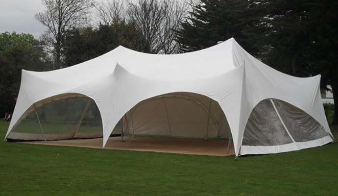White marquee set up on a lawn for an outdoor party