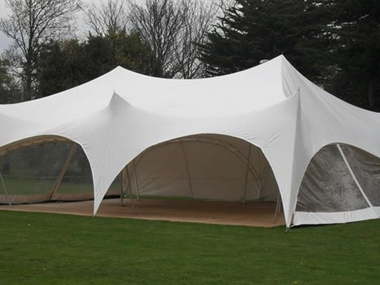 White marquee set up on a lawn for an outdoor party